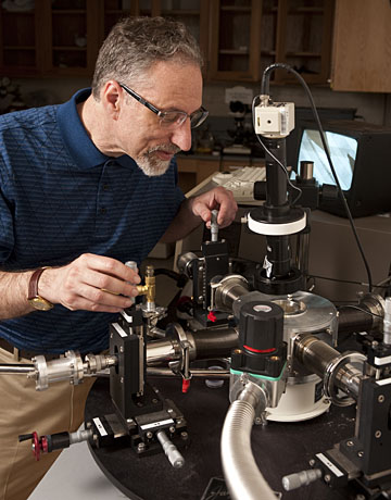 In his material science lab, Howard Katz adjusts probes used for testing electronic devices. Photo by Will Kirk Homewoodphoto.jhu.edu