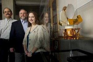 Jessica Noviello is Student No. 1 in a space science and engineering minor co-directed by Joseph Katz, left, and Charles L. Bennett. In the case is a model of NASA’s Wilkinson Microwave Anisotropy Probe spacecraft, a mission for which Bennett serves as principal investigator. Photo by Will Kirk/homewoodphoto.jhu.edu